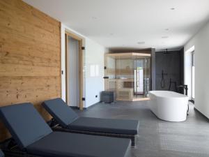 a bathroom with a tub and a bath tub at Chalet Wachterfeld in Berchtesgaden
