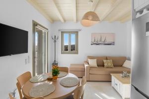 a living room with a table and a couch at Villa Zaneta with swimming pool in Prodromos Paros