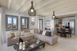 a living room with a couch and a table at Villa Zaneta with swimming pool in Prodromos Paros