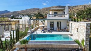a villa with a swimming pool and a house at Villa Zaneta with swimming pool in Prodromos Paros