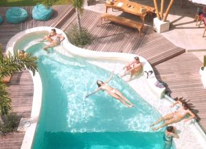 a group of men swimming in a swimming pool at Tipsea Turtle Gili Trawangan in Gili Trawangan