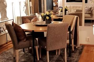 a dining room with a table and chairs with flowers on it at Central apartment with 2 bedrooms in Tromsø