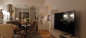 a living room with a television and a dining room at Central apartment with 2 bedrooms in Tromsø