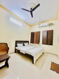 a bedroom with a bed and a ceiling fan at Rv stay pushkar in Pushkar