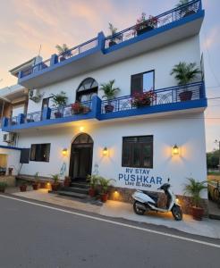 a building with a scooter parked in front of it at Rv stay pushkar in Pushkar