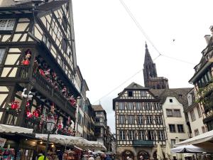 a city street with buildings and a clock tower at Le Coeur Champêtre in Oberhoffen-sur-Moder