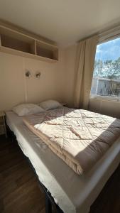 a bed in a room with a window at Le Coin Provençal in Nans-les-Pins +16 photos
