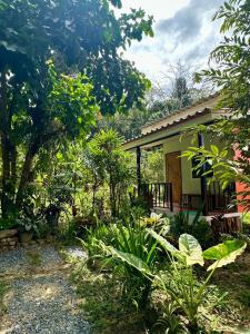 a house with a garden in front of it at Chalee Guest House in Ban Khlong Mat +6 photos