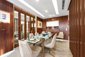 a dining room with a long table and chairs at The sunset resorts - منتجع ساحل الغروب in Jeddah