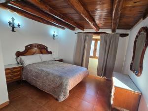 a bedroom with a large bed and a window at Casa La Fuencisla in Castiltierra