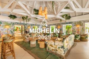 a lobby with couches and a sign that reads mitzlin at Tropical Hotel St Barth in Gustavia