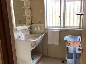 a bathroom with a sink and a mirror at Ichihara city house - Vacation STAY 20067 in Ichihara
