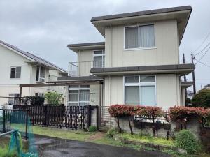 a white house with a fence in front of it at Ichihara city house - Vacation STAY 19997 in Ichihara