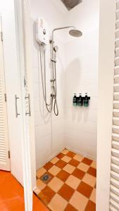 a shower in a bathroom with a checkered floor at The companions house in Sathani Bang Su +25 photos