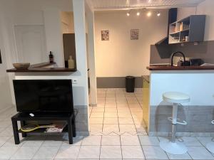 a kitchen with a counter and a stool in a room at Villa Mamalouken App Maloe in Rivière-Pilote +21 photos