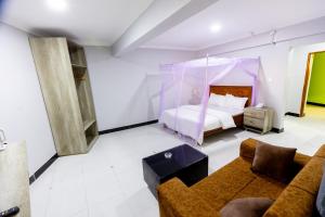 a living room with a bed and a couch at Jade Inn in Arusha