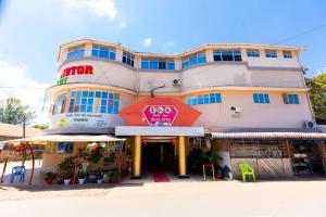 a building with a sign on the front of it at Jade Inn in Arusha