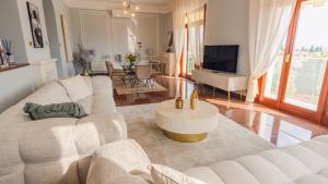 a living room with a white couch and a table at Villa Angela - Italian Homing in Desenzano del Garda