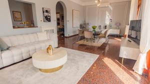a living room with a white couch and a table at Villa Angela - Italian Homing in Desenzano del Garda