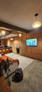 una grande stanza con schermo di proiezione e tavolo di Chalé Sol - Vila Doiideira - centro de Ibitipoca a Lima Duarte