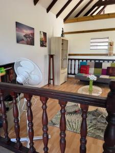 a living room with a table with a fan at T3 cosy haut de villa in Les Abymes