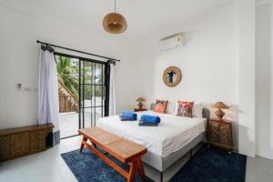 a bedroom with a bed with blue pillows on it at Shanti Rock Residence Koh Phangan in Ko Kong Nui +184 photos