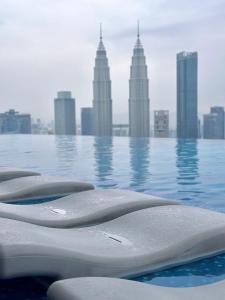 a pool with a view of a city with tall buildings at Eaton Delight Residences in Kuala Lumpur