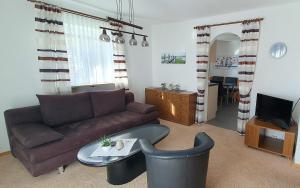 a living room with a couch and a table at Ferienwohnungen Trattler in Chieming