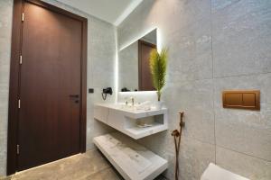 a bathroom with a sink and a mirror at Al- Abasly Suites in Baghdād +28 photos