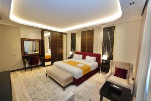a hotel room with a bed and a chair at Al- Abasly Suites in Baghdād