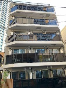 an apartment building with balconies on the side of it at Minami Ikebukuro APT Dear Cosmo Ikebukuro subway 6mins in Tokyo