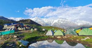 a group of tents on a hill with mountains at Himachal Adventure in Dharamshala