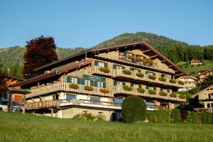a large building with balconies on a mountain at Hôtel Les Roches Fleuries in Cordon