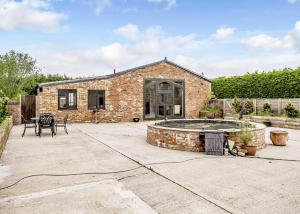 a brick house with a patio with a pool at Ladera Retreat Lodges in Eaton