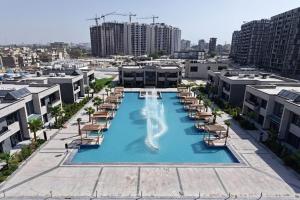 an overhead view of a swimming pool with lounge chairs and a swimming pool at Al-Abasly Family Resort in Baghdad
