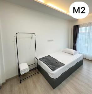a white bedroom with a bed and a mirror at Monday Guesthouse2 Hatyai in Hat Yai +10 photos