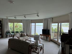 a living room with a view of the water at Family Vacation Home - Stunning Views across Salt Pond in Bethany Beach