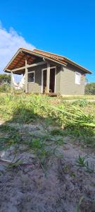 a house on a hill with grass in front of it at Moradas do Maneca Chalé da Lagoa in Imbituba