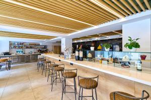 a bar in a restaurant with chairs and a counter at Hotel Melibea by gaiarooms in Salamanca