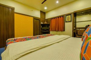 a hotel room with two beds in a room at FabHotel Shivalya in Kolkata
