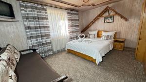 a bedroom with a bed and a tv in a room at "Як вдома" Буковель in Bukovel +88 photos