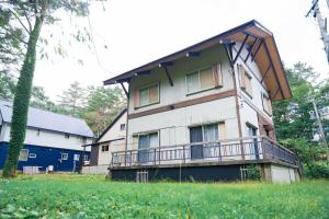 a house with a balcony on the side of it at The Sake Kura villa in Hakuba