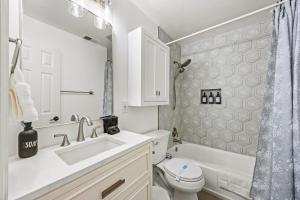a white bathroom with a sink and a toilet at - 5-Min Walk To Metro - Free Prking - Escape in Alexandria +19 photos