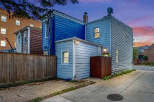 a blue house with a fence in front of it at - Free Parking & 5-Min Walk To Metro - Book Now! in Alexandria