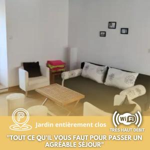 a living room with a couch and a table at Les 4c-calm-central-close to Prenois circuit in Velars-sur-Ouche