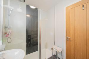 a bathroom with a shower and a toilet and a sink at The Lodge House Callander in Callander