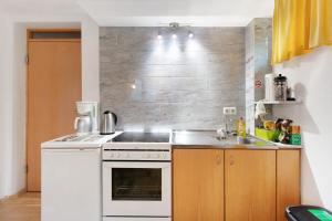 a kitchen with a white stove and a sink at Haus am Apfelbaum in Bad Säckingen