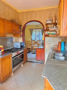 a kitchen with a sink and a stove top oven at J&T Homestay in Karatu +50 photos