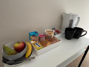 a counter with a bowl of food and a bowl of fruit at East Halton Hotel in East Halton