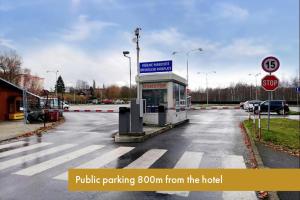 a bus stop in a parking lot with a stop sign at Spa Hotel Goethe in Františkovy Lázně